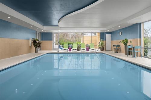 a large swimming pool with blue water in a building at Home2 Suites Nashville Airport in Nashville