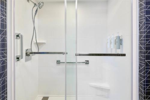 a shower with a glass door in a bathroom at Homewood Suites by Hilton Orlando-UCF Area in Orlando