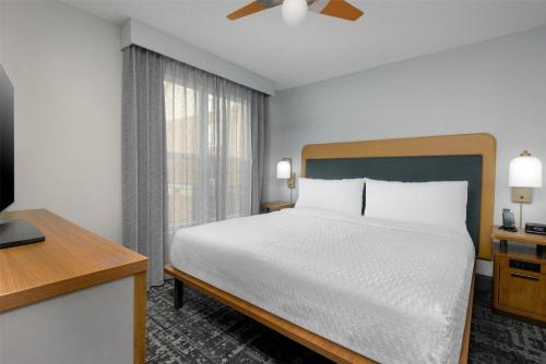 a hotel room with a bed and a window at Homewood Suites by Hilton Orlando-UCF Area in Orlando