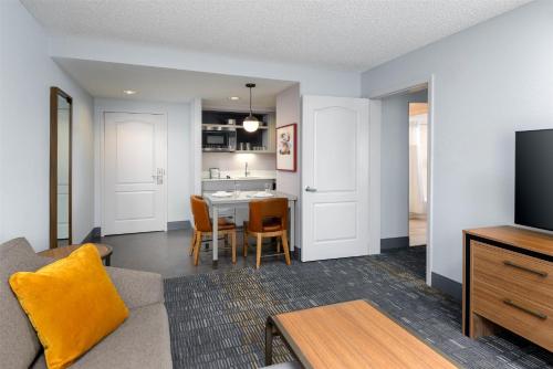 a living room with a couch and a table at Homewood Suites by Hilton Orlando-UCF Area in Orlando