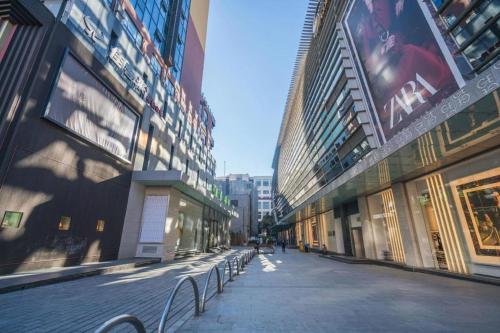 an empty street in a city with tall buildings at Kunming Golden Eagle Summit Hotel in Kunming