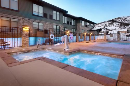 a swimming pool in a yard with a house at Hyatt Place Park City in Park City