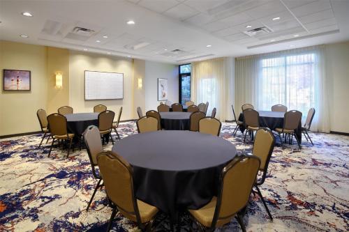 a conference room with tables and chairs and a whiteboard at Hyatt Place Park City in Park City