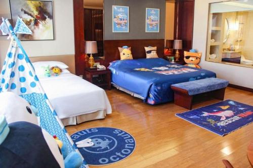 a bedroom with two beds and a christmas tree at Kunming Golden Eagle Summit Hotel in Kunming