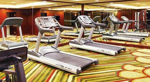 a row of exercise bikes in a gym at Kunming Golden Eagle Summit Hotel in Kunming