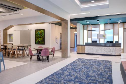 a rendering of a lobby with a dining area at Home2 Suites By Hilton Smithfield Selma in Smithfield
