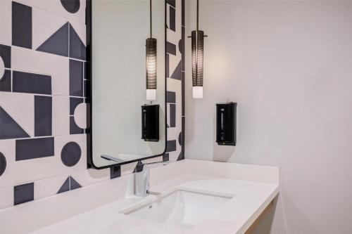 a bathroom with a sink and a mirror at Home2 Suites By Hilton Smithfield Selma in Smithfield