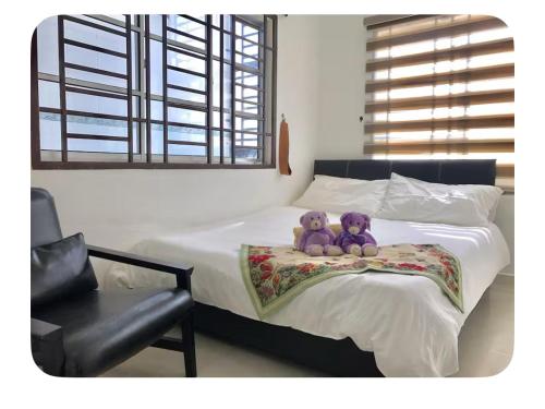 two teddy bears sitting on top of a bed at Semi D 4BR 1min to KSL & Holiday Plaza 8-10pax in Johor Bahru