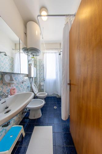 a bathroom with two toilets and a sink at Vista mare,Residence albatross in Lido Adriano