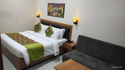 a bedroom with a bed and a couch at Ai 360 Degree Hotel Lansdowne in Lansdowne