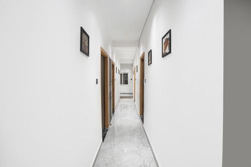 a hallway of a house with white walls at FabHotel The Shivaay Palace in Varanasi