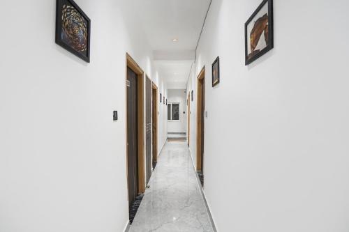 a corridor of a house with white walls at FabHotel The Shivaay Palace in Varanasi