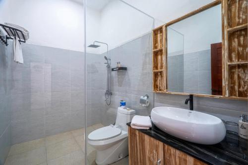 a bathroom with a sink and a toilet at Angseri Villas in Tabanan