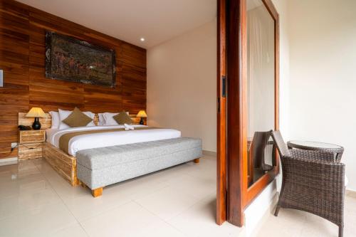 a bedroom with a bed with a wooden wall at Angseri Villas in Tabanan