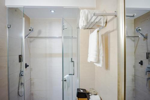 a bathroom with a shower and a glass shower stall at Beijing Shichahai Shadow Art Performance Courtyard in Beijing