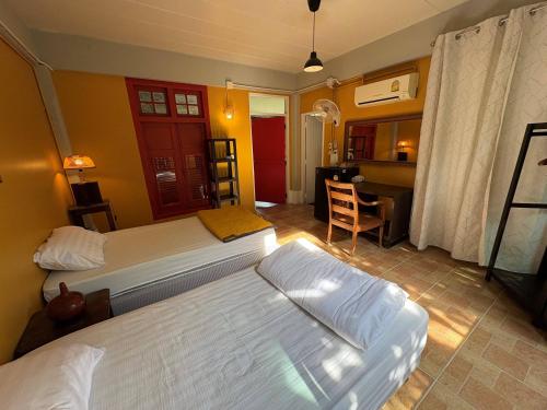 Postel nebo postele na pokoji v ubytování Golden Mango House