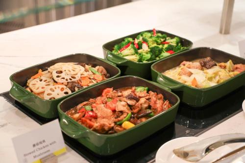 a group of four trays of food on a table at The Westin Wuhan Hanyang in Wuhan