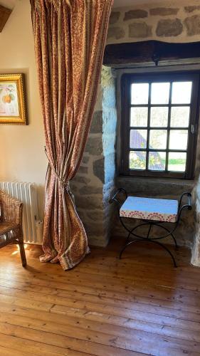 a room with a window with a bench in front of it at Chambres d'Hôtes Belle Vallee in Domfront