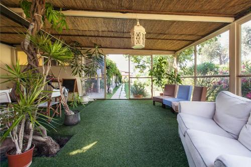 an outdoor living room with a couch and chairs at Agriturismo Podere L'Agave in San Vincenzo