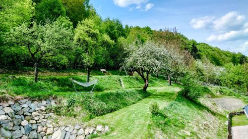 a hammock in a garden next to a tree at Cha-lu-pa in Šumperk