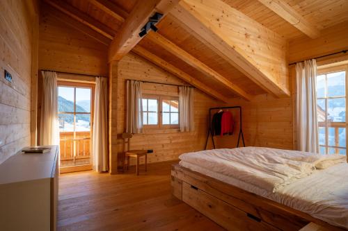 a bedroom with a bed in a wooden house at Mountain Lodge Stummerberg in Stummerberg