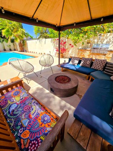 a patio with couches and a table and an umbrella at Luxury Guesthouse in Los Angeles