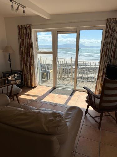 a living room with a couch and a view of the ocean at ONeills Apartments in Ballyheigue