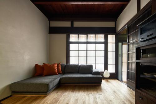 a living room with a couch and a large window at YADORU KYOTO HANARE Shirotaki No Yado in Kyoto