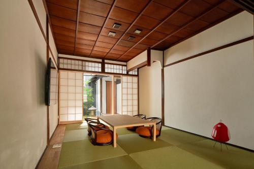 a room with a table and chairs in it at YADORU KYOTO HANARE Shirotaki No Yado in Kyoto