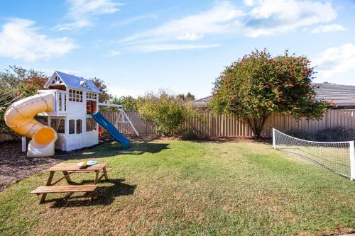 a backyard with a playground with a slide at Halcyon Haven in Aldinga Beach