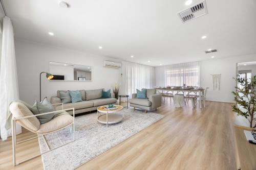 a living room with a couch and a table at Halcyon Haven in Aldinga Beach