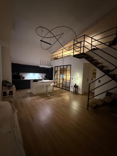 a living room with a table and a spiral staircase at OLIVOMARE in Kyparissia
