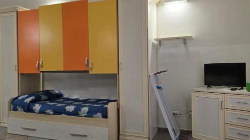 a bedroom with a bunk bed and a tv at Le Plejadi in Castellammare del Golfo