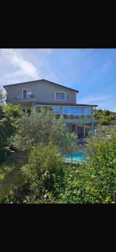 a large house with a pool in front of it at Qyteza Guest House & Camping in Shkodër