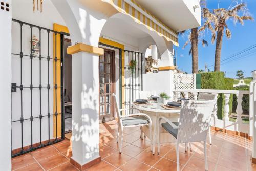 a balcony of a house with a table and chairs at La Campana apt with pool by Costarentals - Ref 60 in Santa Fe de los Boliches