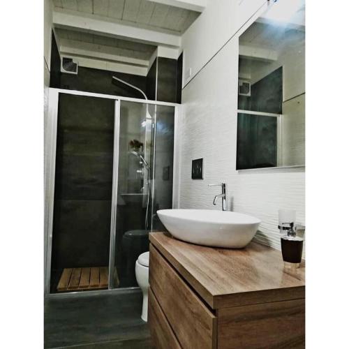 a bathroom with a sink and a toilet and a shower at Nina casa vacanze in Leverano