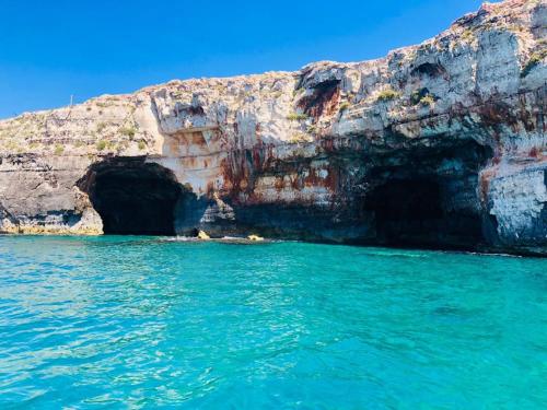 a cave in the ocean next to a cliff at Nina casa vacanze in Leverano