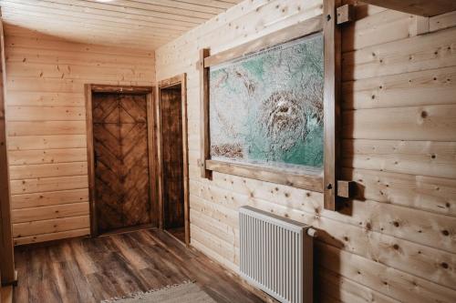 a room with wooden walls and a painting on the wall at Rekreačný dom - Chata pod Lampášom in Terchová