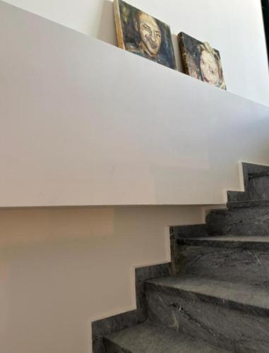 a stairway with pictures of people on the wall at Luxury Maisonette with Shared Pool in Athens