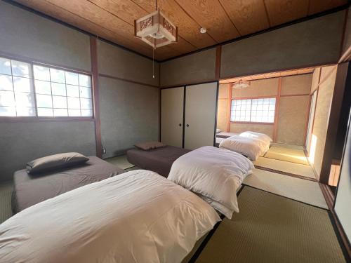Postel nebo postele na pokoji v ubytování くくのちステイ 棚田が見えるゲストハウス