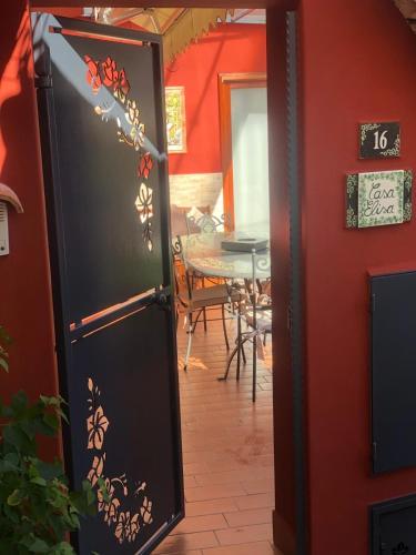 a black refrigerator in a room with a table at Positano Casa Elisa in Positano