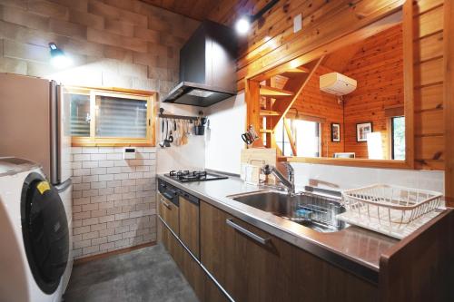 a kitchen with a sink and a counter top at The Creek Cottage in Habu