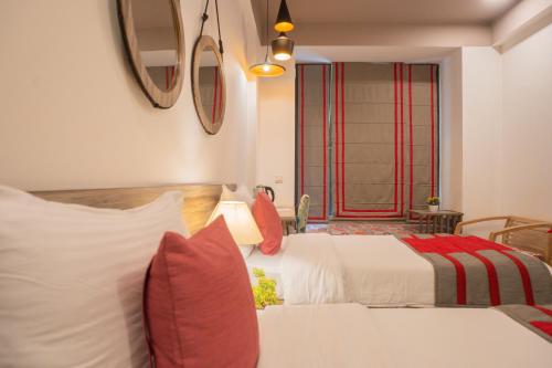 a hotel room with two beds and a window at Ahuja Residency Parklane in Gurgaon