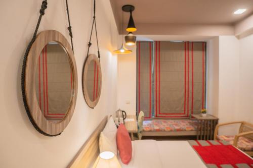 a bedroom with two mirrors on the wall and a bed at Ahuja Residency Parklane in Gurgaon