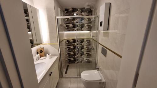 a bathroom with a shower and a toilet and a sink at Elite Luxury Suite - Elize 4 in Alanya