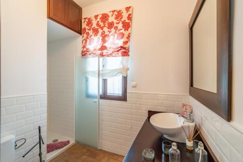 a bathroom with a sink and a refrigerator at Casa rural Pozo Viejo in Marchena