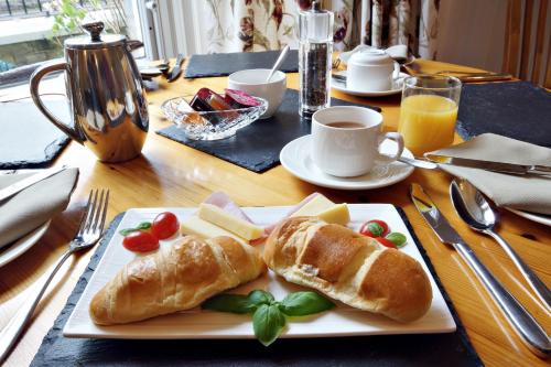 a plate with two croissants and cheese on a table at Bronte Guest House in York