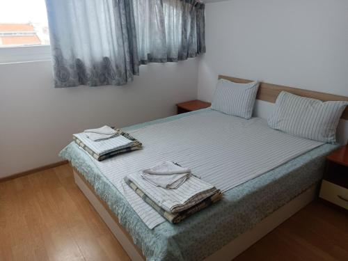 a bedroom with a bed with towels on it at Penthaus Cacao Beach in Sunny Beach