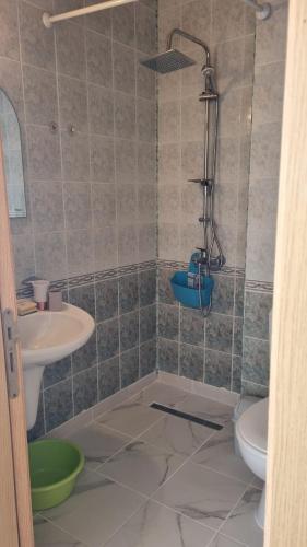 a bathroom with a shower and a toilet and a sink at Penthaus Cacao Beach in Sunny Beach
