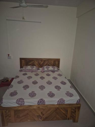 a bedroom with a bed with a flower pattern on it at Prashant Homestay & Villa, Alibag in Alibaug